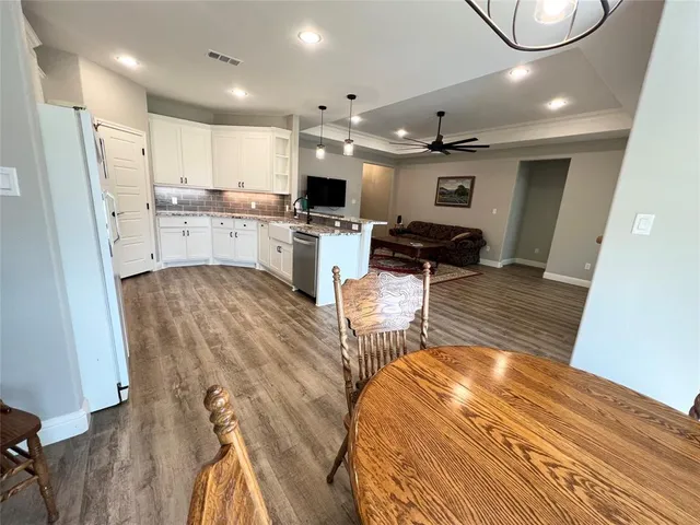 a view of kitchen with cabinets and wooden floor