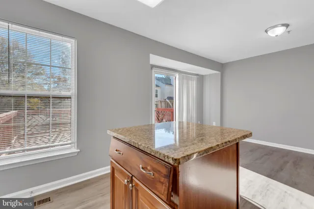 a view of kitchen island with granite countertop window