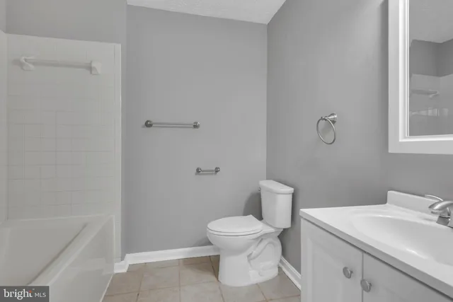 a bathroom with a toilet a sink and bathtub