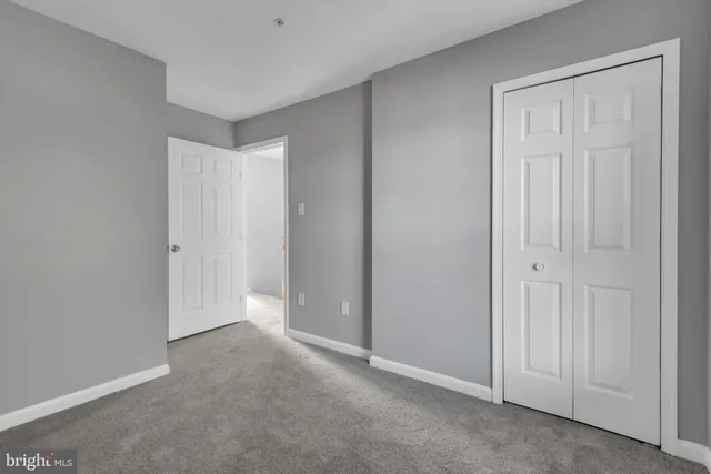 an empty room with closet area