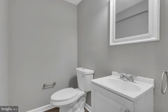 a white toilet sitting next to a bathroom sink