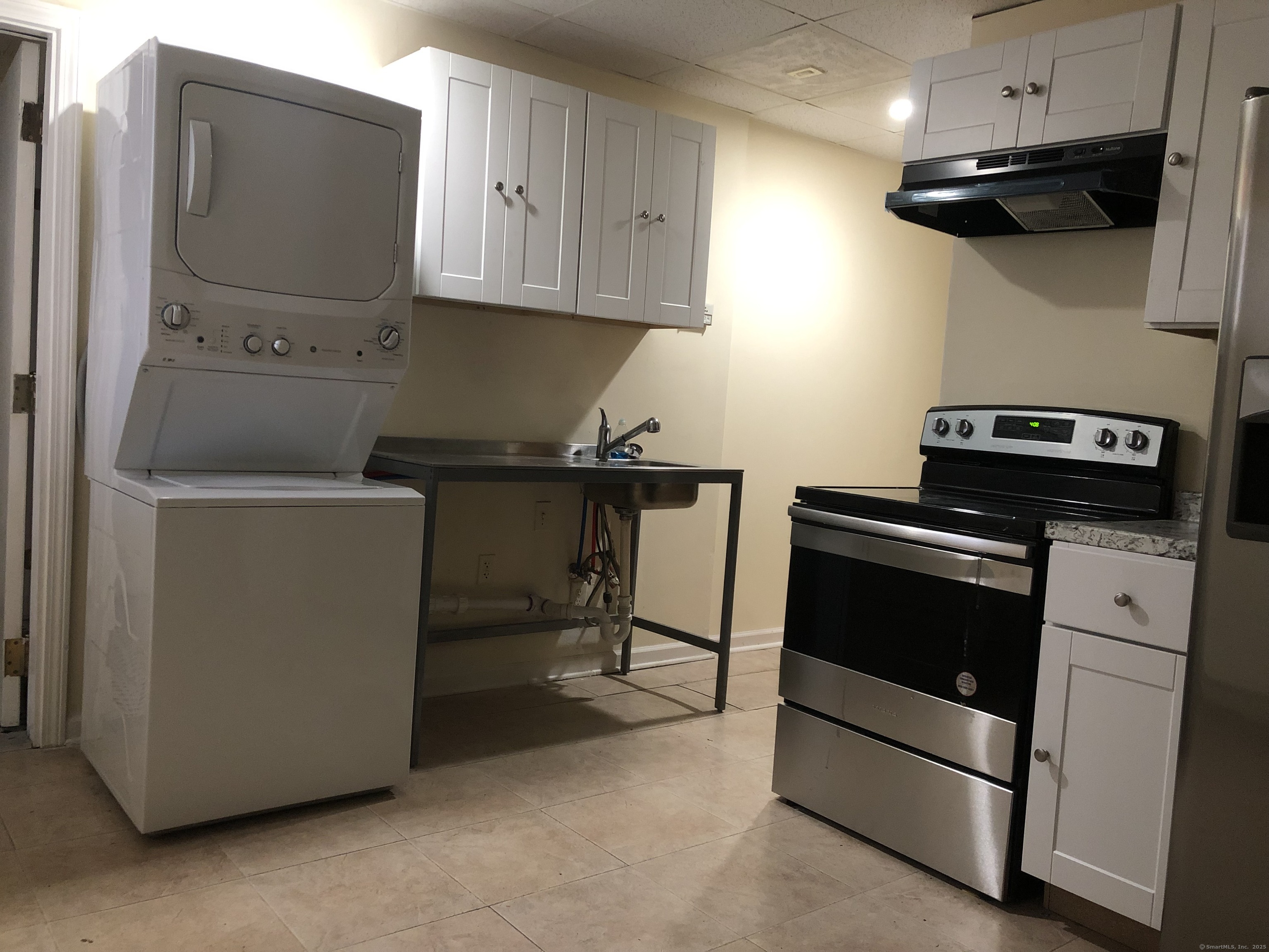 1399 State Street, Unit 5B New Haven, CT 06511 - Photo 2 of 6 a kitchen with a stove and a microwave
