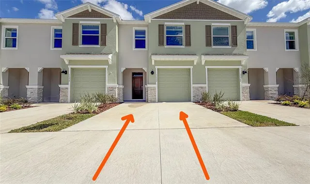 a kitchen with a sink a microwave a refrigerator and cabinets