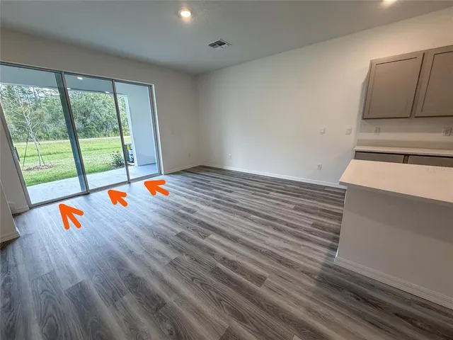 an empty room with wooden floor and door