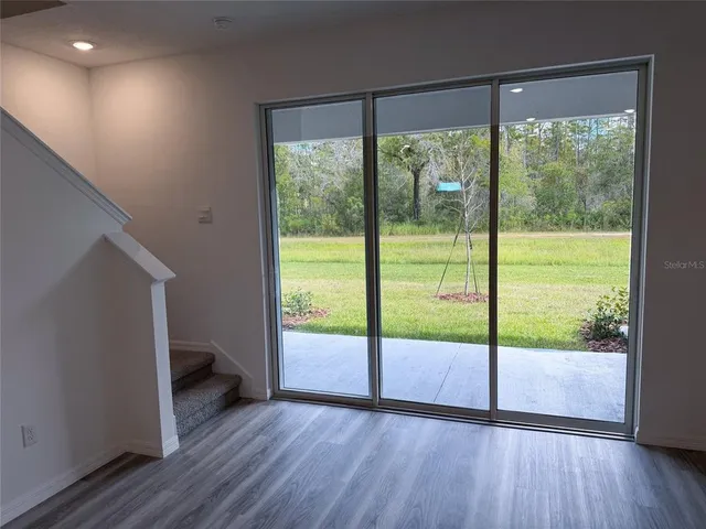 a view of a kitchen with a sink and dishwasher a refrigerator with wooden floor