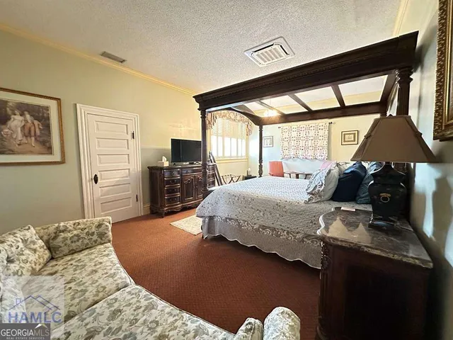 a bedroom with a bed and dresser with mirror