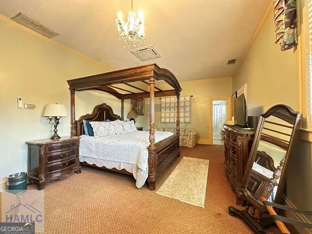a bedroom with furniture and a chandelier