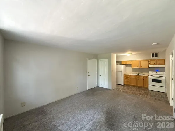 a view of a kitchen with a sink and a refrigerator