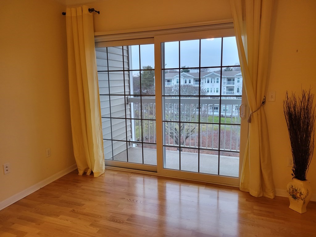 9 Abigail Way, Unit 4010 Reading, MA 01867 - Photo 12 of 37 a view of wooden floor and windows in a room