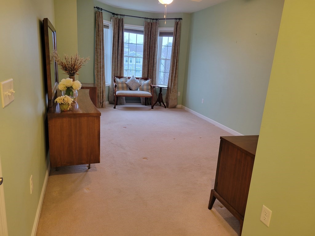 9 Abigail Way, Unit 4010 Reading, MA 01867 - Photo 13 of 37 a living room with furniture and a window