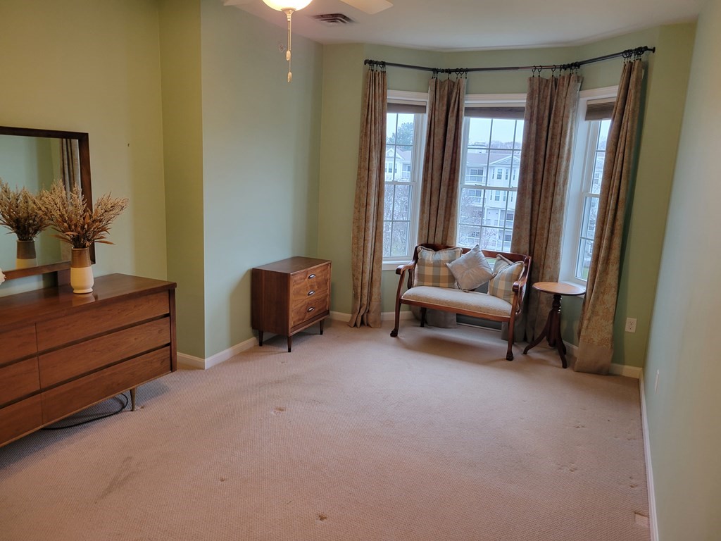 9 Abigail Way, Unit 4010 Reading, MA 01867 - Photo 14 of 37 a living room with furniture and a window