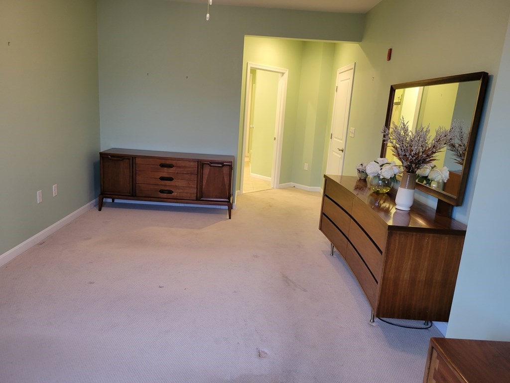 9 Abigail Way, Unit 4010 Reading, MA 01867 - Photo 15 of 37 a living room with furniture and a flat screen tv