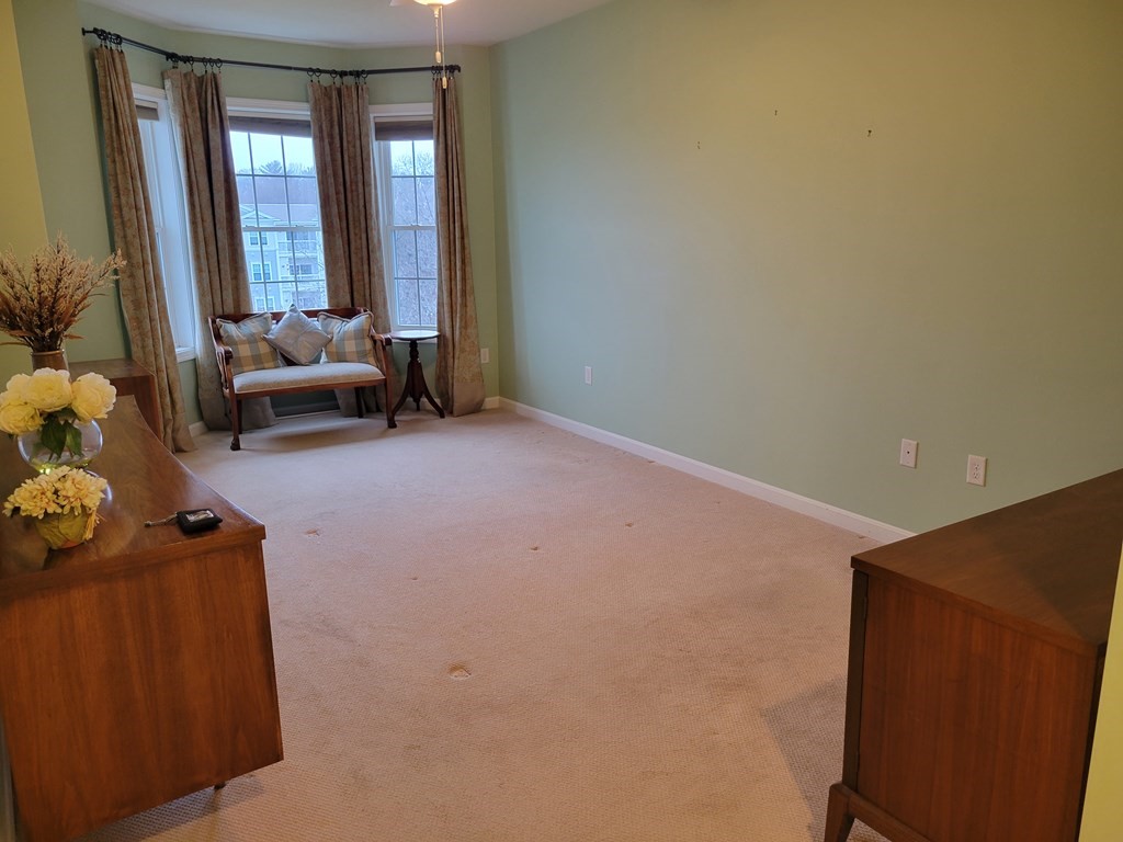 9 Abigail Way, Unit 4010 Reading, MA 01867 - Photo 16 of 37 a living room with furniture and large windows