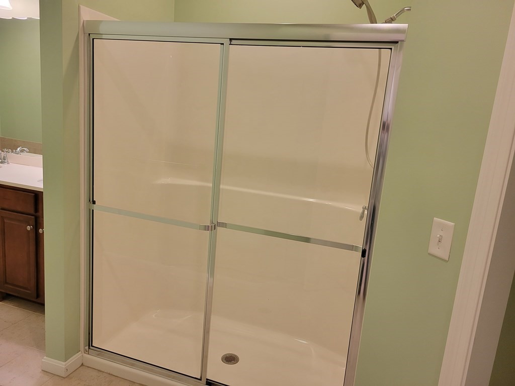 9 Abigail Way, Unit 4010 Reading, MA 01867 - Photo 19 of 37 a bathroom with a glass shower door