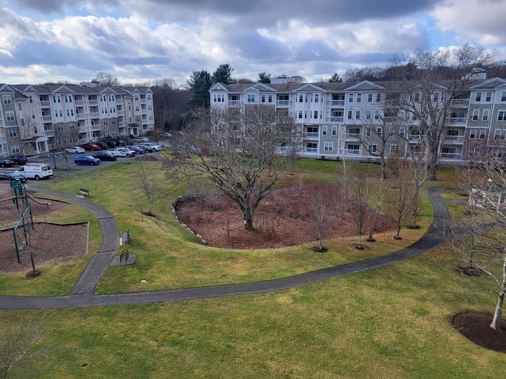 9 Abigail Way, Unit 4010 Reading, MA 01867 - Photo 2 of 37 a view of a water with a building in the background