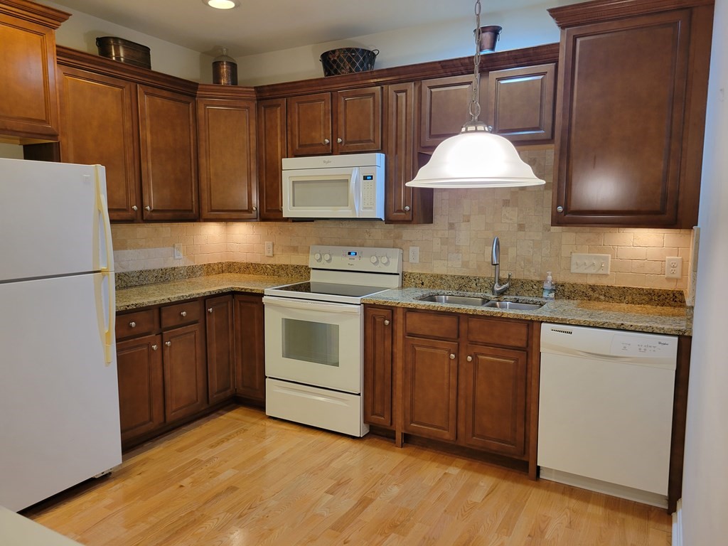 9 Abigail Way, Unit 4010 Reading, MA 01867 - Photo 26 of 37 a kitchen with a sink cabinets and appliances