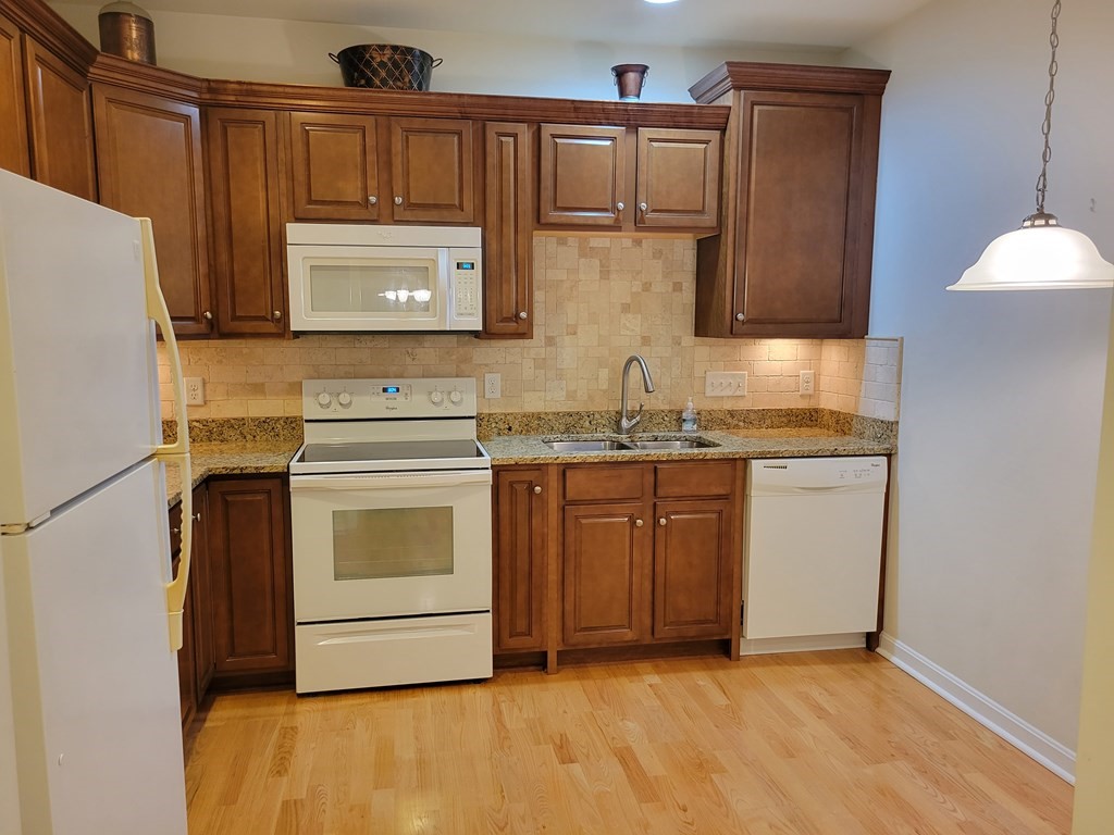 9 Abigail Way, Unit 4010 Reading, MA 01867 - Photo 27 of 37 a kitchen with stainless steel appliances granite countertop a sink stove and refrigerator