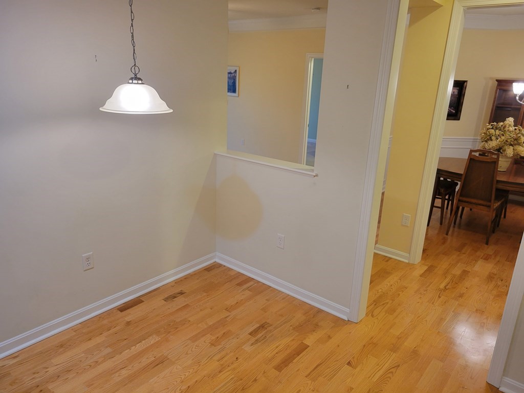 9 Abigail Way, Unit 4010 Reading, MA 01867 - Photo 28 of 37 an empty room with wooden floor and windows
