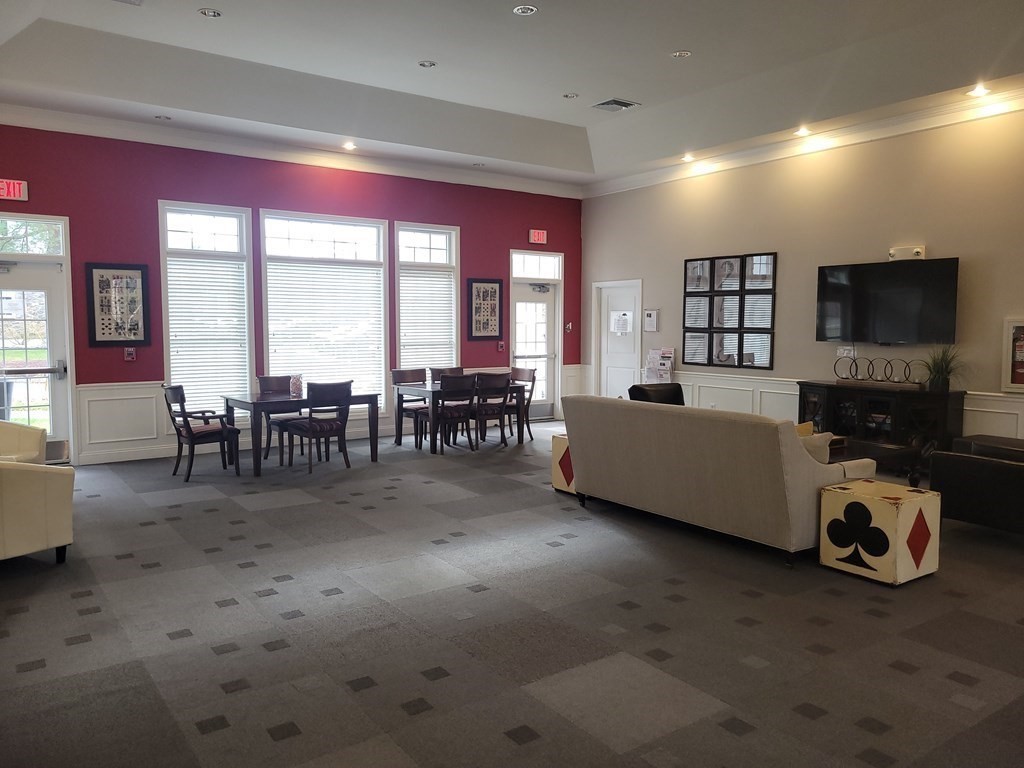 9 Abigail Way, Unit 4010 Reading, MA 01867 - Photo 31 of 37 a living room with furniture and a flat screen tv