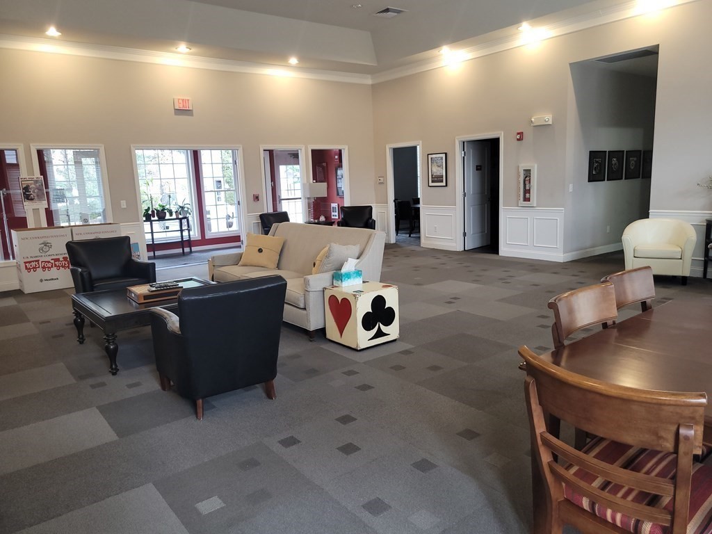 9 Abigail Way, Unit 4010 Reading, MA 01867 - Photo 35 of 37 a living room with furniture and a flat screen tv