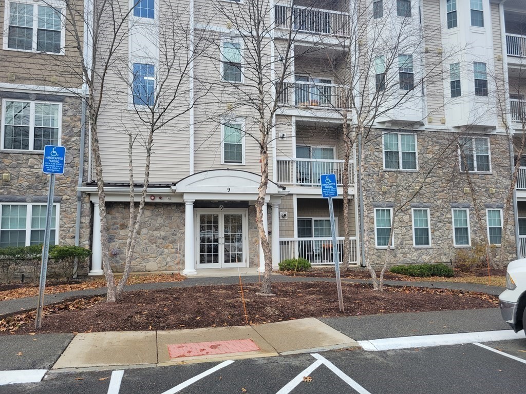 9 Abigail Way, Unit 4010 Reading, MA 01867 - Photo 4 of 37 a front view of a building with windows
