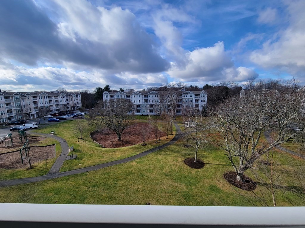 9 Abigail Way, Unit 4010 Reading, MA 01867 - Photo 5 of 37 a view of a swimming pool with lawn chairs and a yard