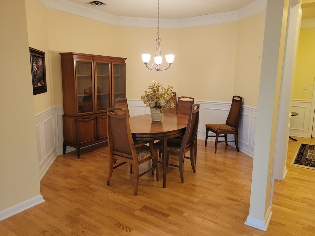 9 Abigail Way, Unit 4010 Reading, MA 01867 - Photo 10 of 37 a view of a dining room with furniture and wooden floor