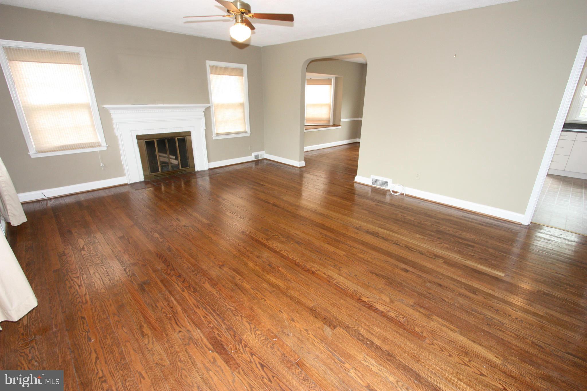 1932 Edgewood Road Parkville, MD 21286 - Photo 11 of 30 an empty room with wooden floor fireplace and windows