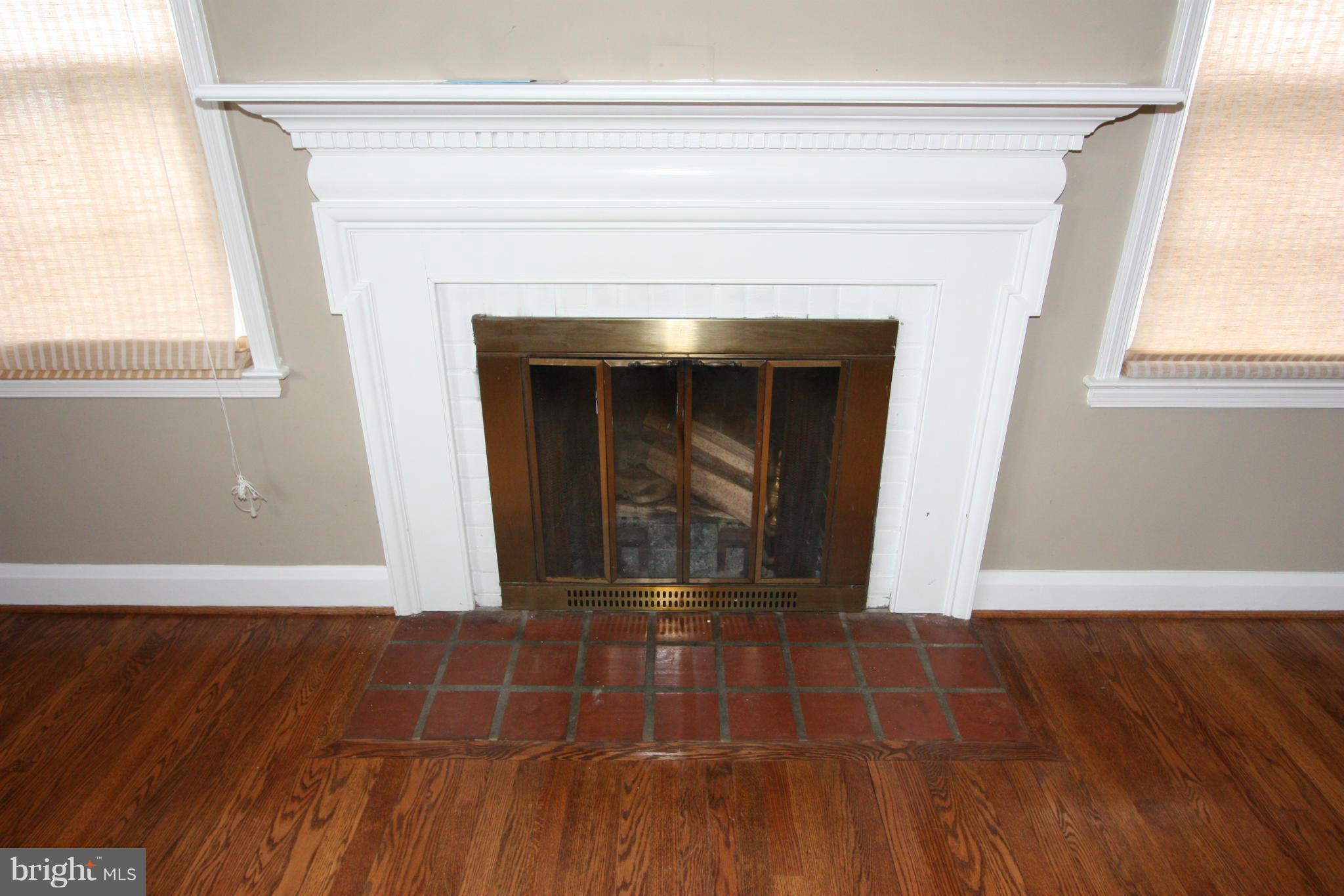 1932 Edgewood Road Parkville, MD 21286 - Photo 13 of 30 a view of empty room with wooden floor and fireplace
