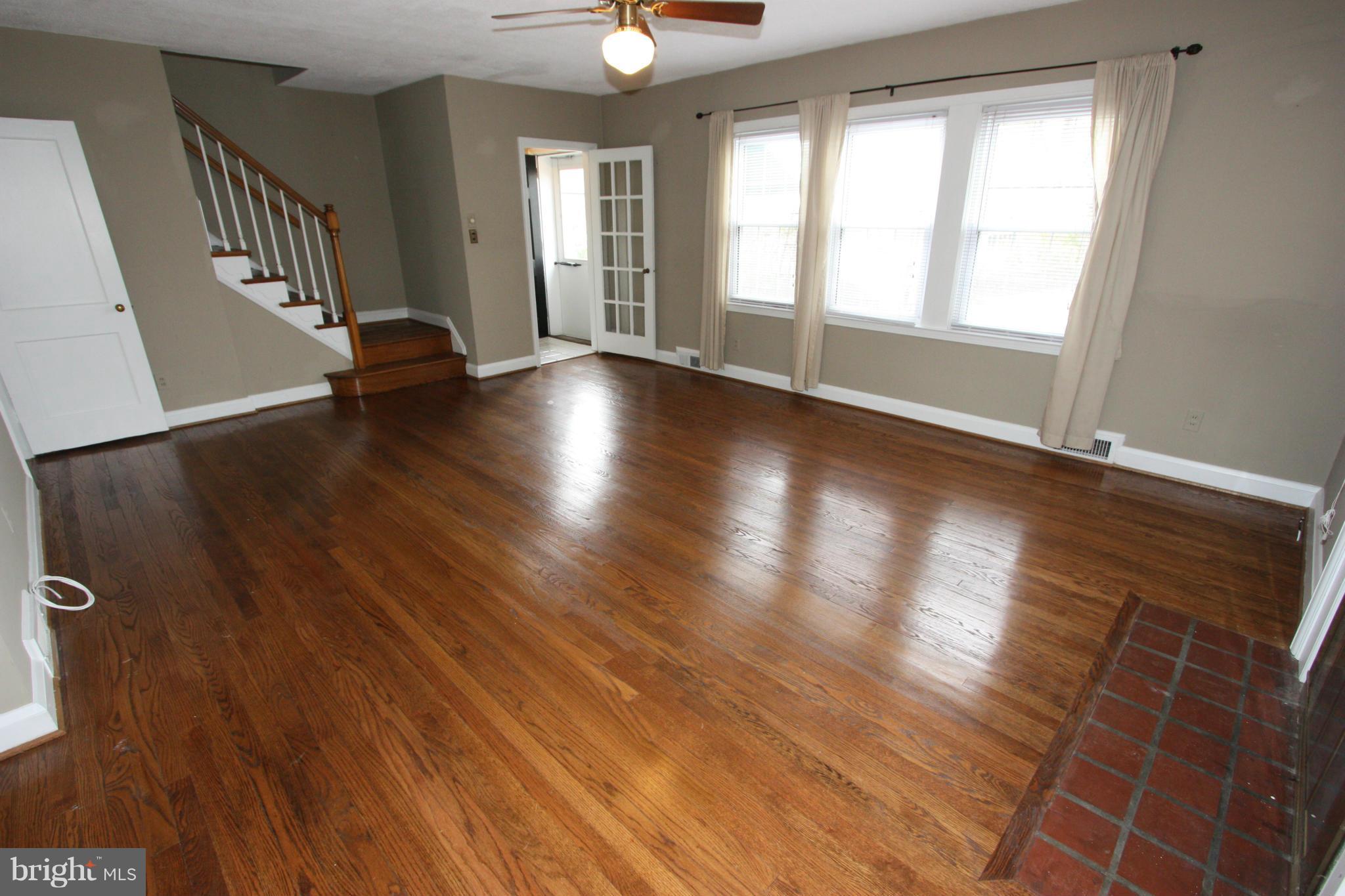 1932 Edgewood Road Parkville, MD 21286 - Photo 14 of 30 an empty room with wooden floor and windows