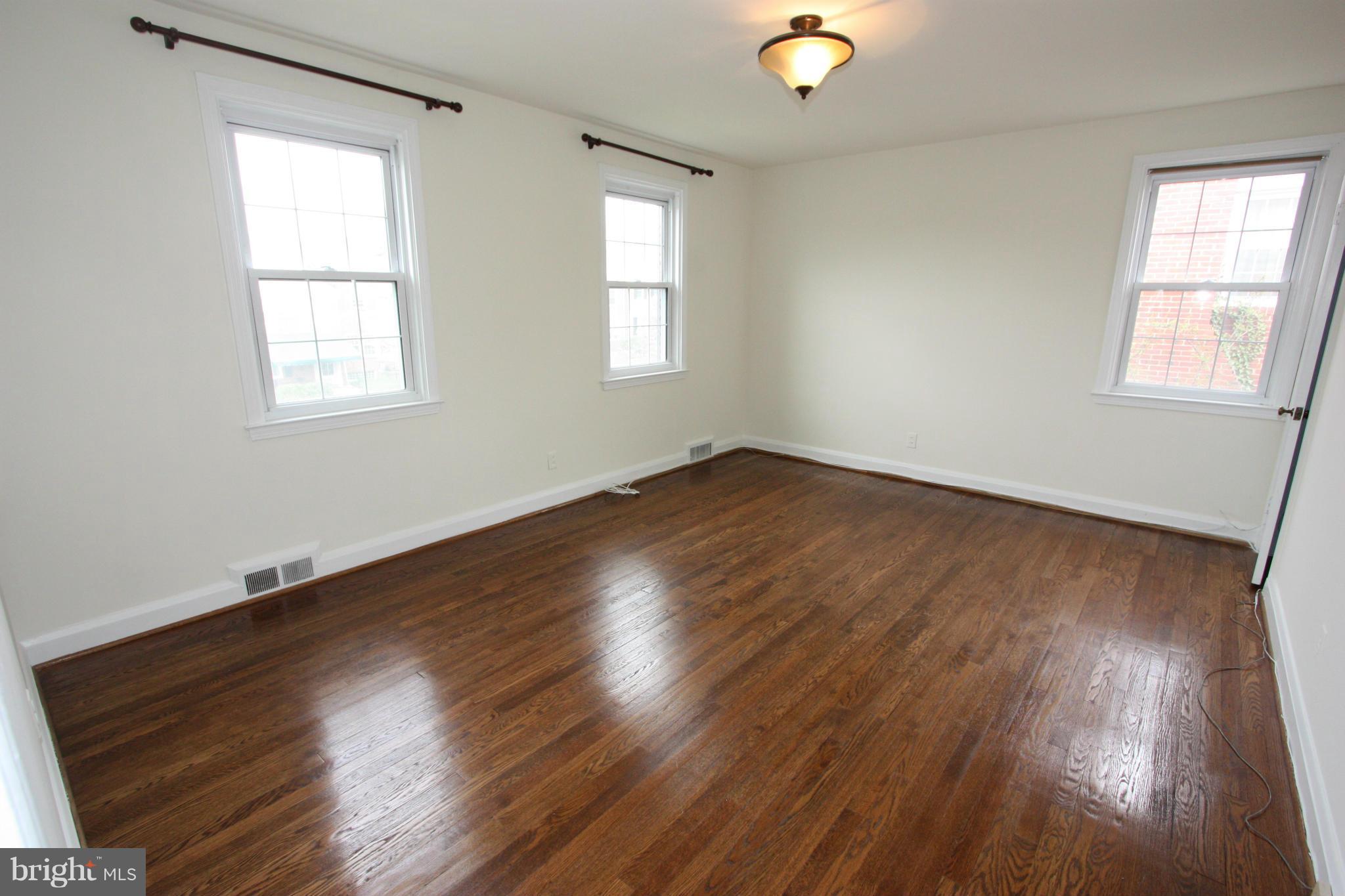 1932 Edgewood Road Parkville, MD 21286 - Photo 16 of 30 a view of an empty room with wooden floor and a window