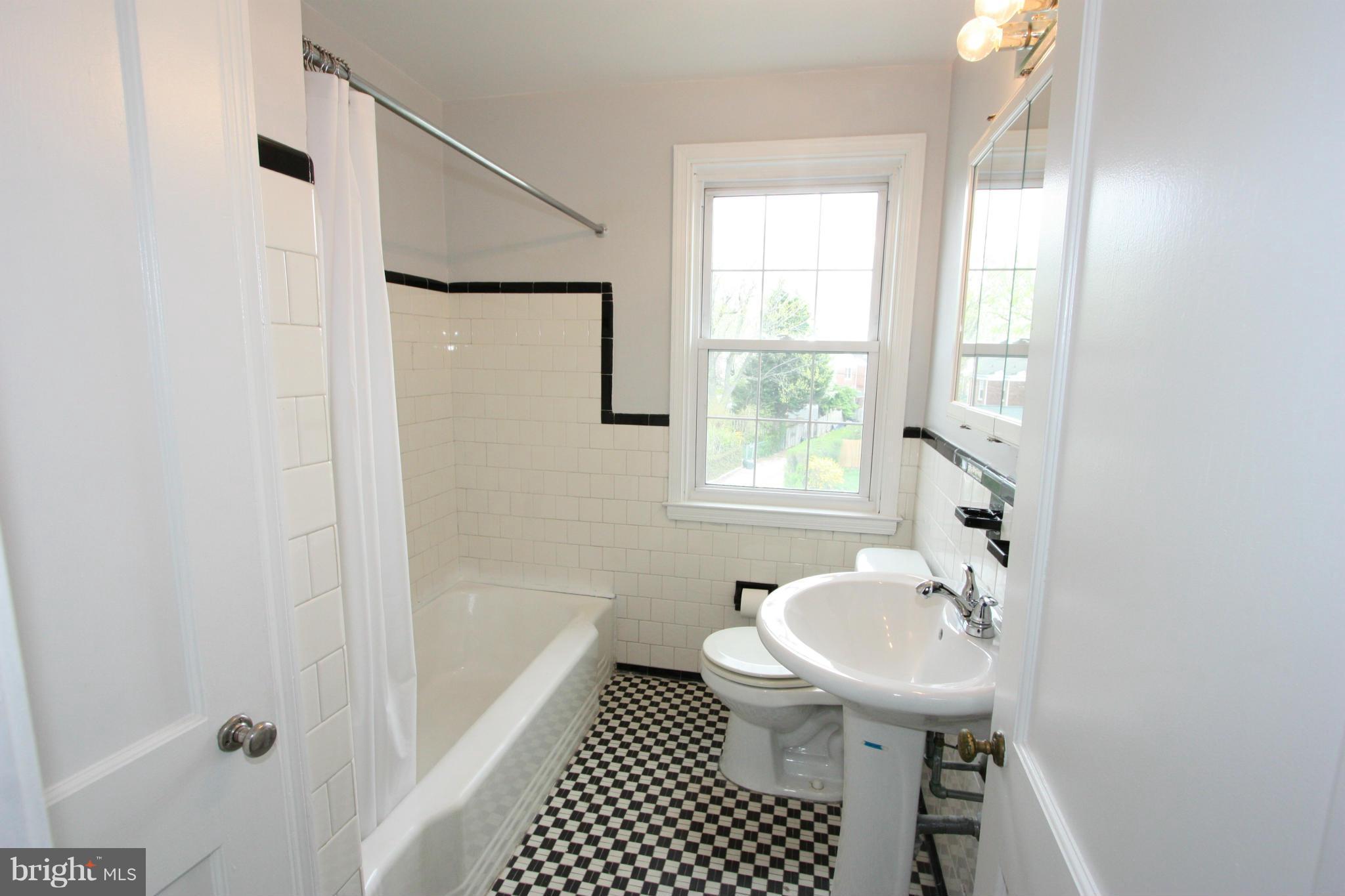 1932 Edgewood Road Parkville, MD 21286 - Photo 17 of 30 a bathroom with a sink a toilet and shower