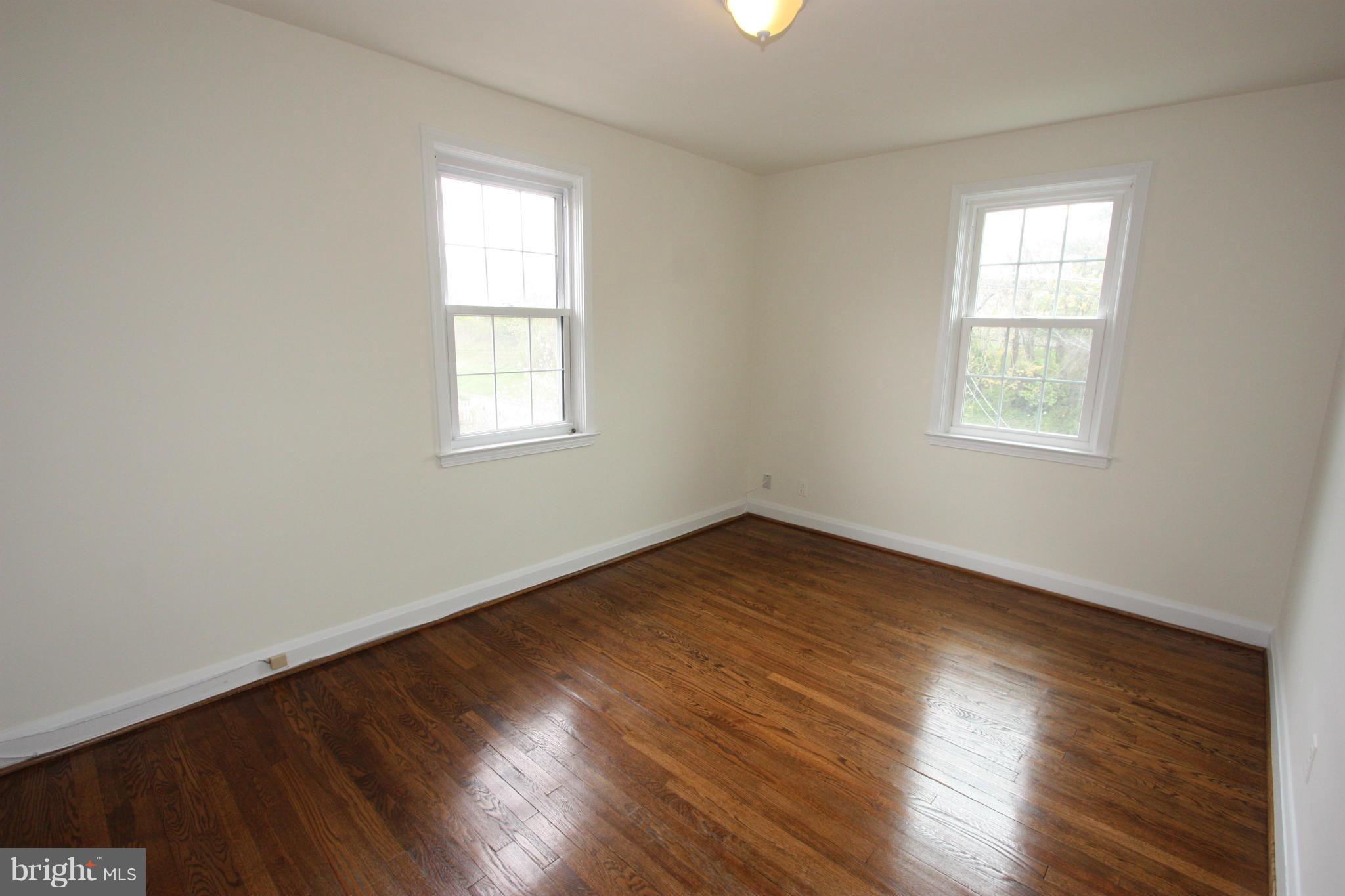 1932 Edgewood Road Parkville, MD 21286 - Photo 20 of 30 an empty room with wooden floor and windows