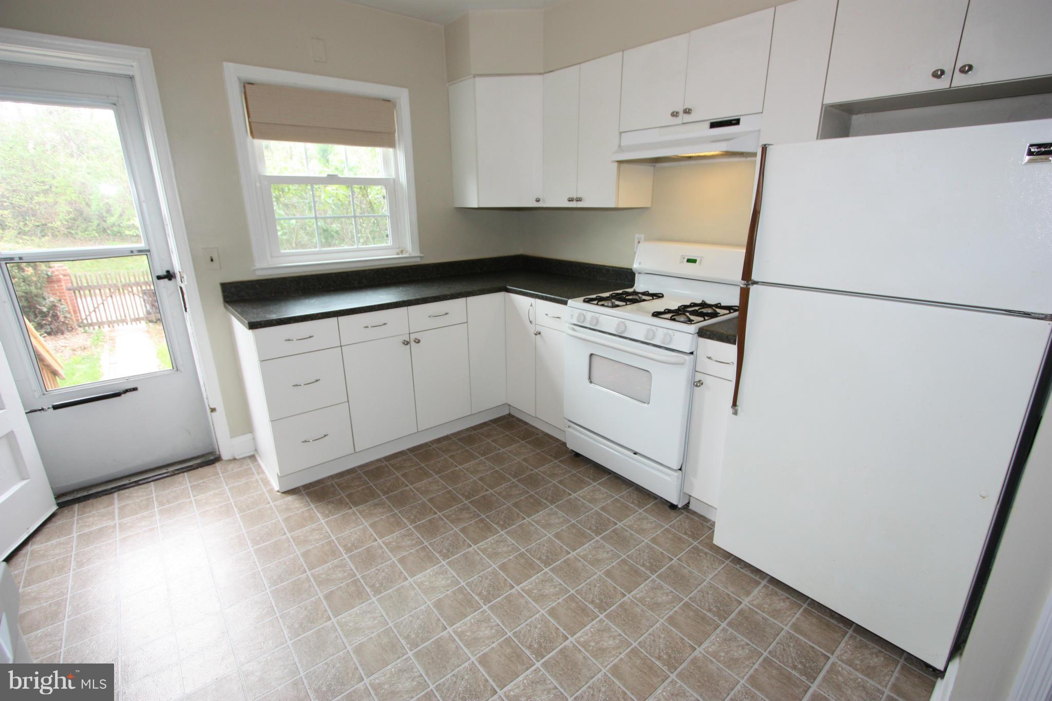 1932 Edgewood Road Parkville, MD 21286 - Photo 4 of 30 a kitchen with a white cabinets and white appliances
