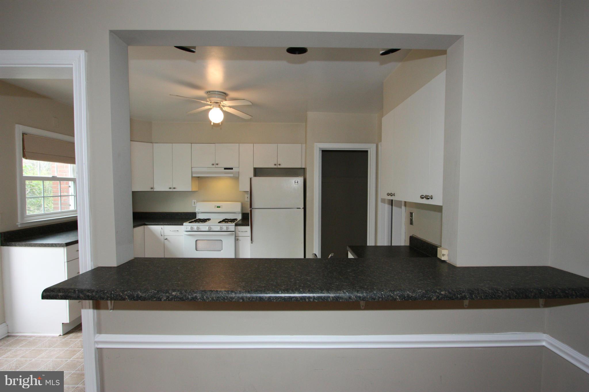 1932 Edgewood Road Parkville, MD 21286 - Photo 7 of 30 a kitchen with kitchen island a counter top space a sink stainless steel appliances and cabinets