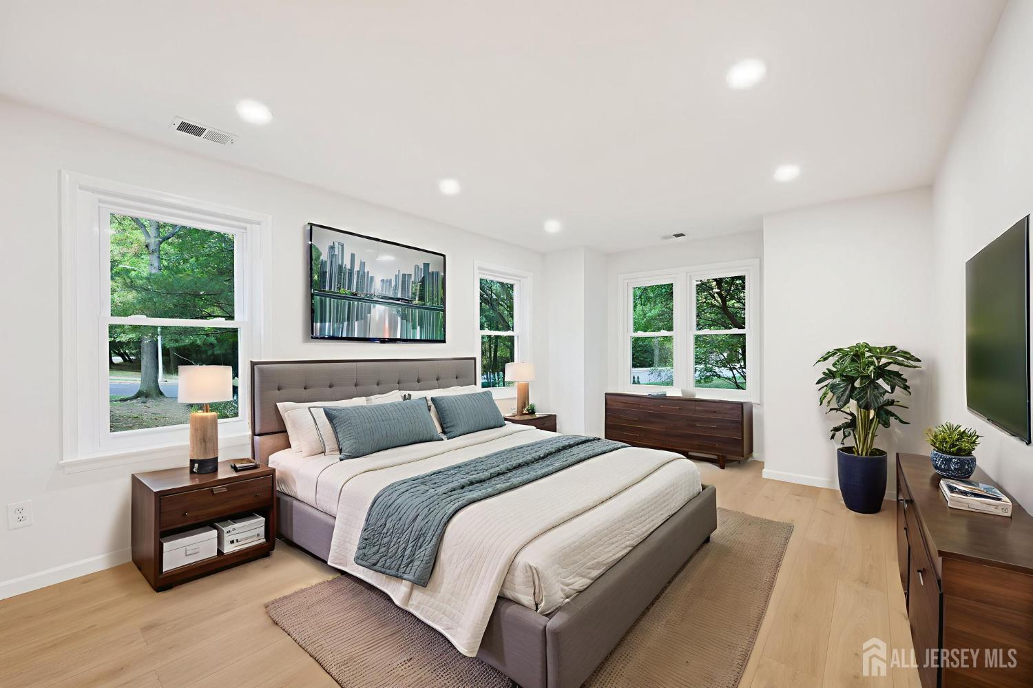 102 Raintree Court Helmetta, NJ 08828 - Photo 12 of 21 a bedroom with a large bed and a potted plant