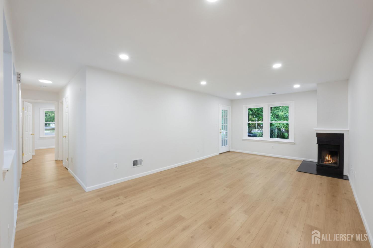 102 Raintree Court Helmetta, NJ 08828 - Photo 3 of 21 a view of an empty room with wooden floor and a window
