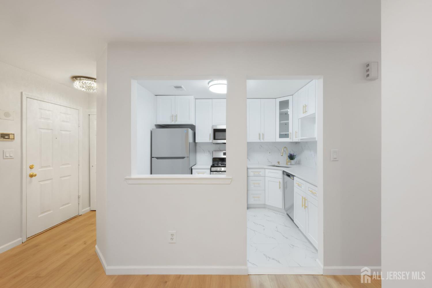 102 Raintree Court Helmetta, NJ 08828 - Photo 8 of 21 a kitchen with white cabinets and white appliances