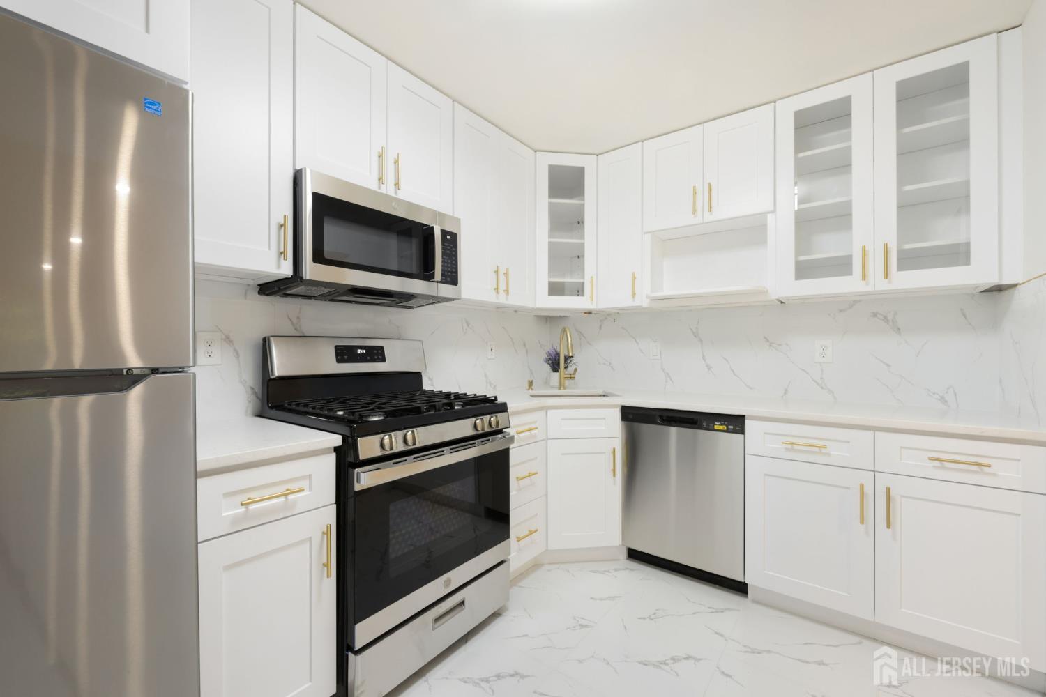 102 Raintree Court Helmetta, NJ 08828 - Photo 9 of 21 a kitchen with stainless steel appliances white cabinets a stove top oven a sink and dishwasher
