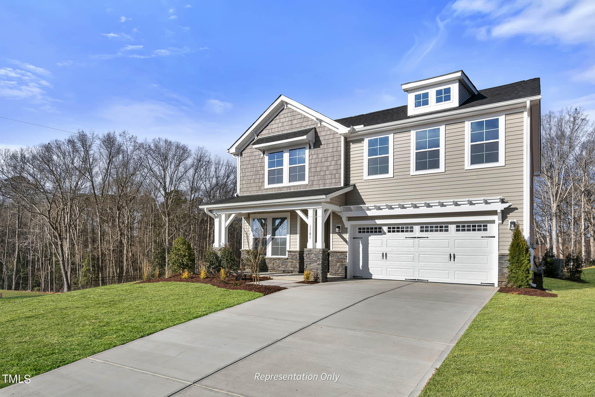 8720 Maxine Street, Unit 3 Willow Spring, NC 27592 - Photo 2 of 35 a front view of a house with a yard and garage