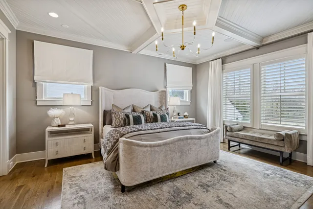 a bedroom with a bed and a chandelier