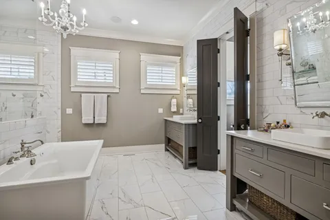 a spacious bathroom with a double vanity sink a mirror and a shower