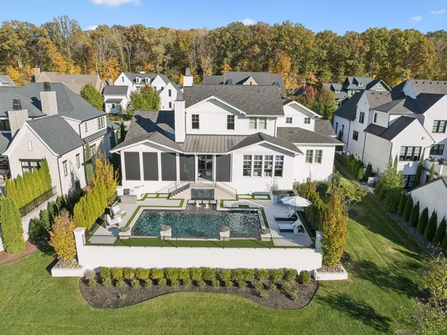a front view of a house with a yard and outdoor seating