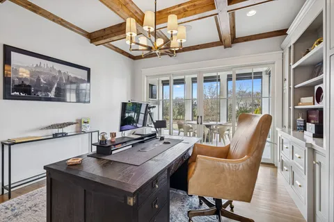 a view of a livingroom with furniture and a bookshelf
