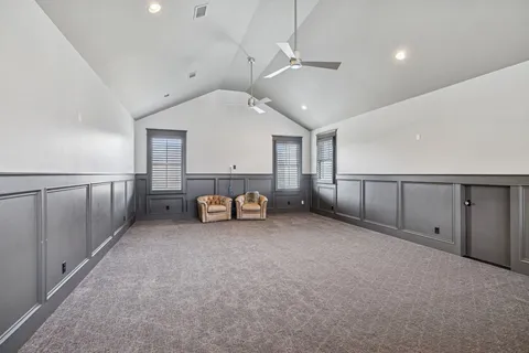 an empty room with fireplace and windows