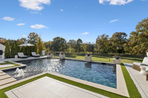 a view of a swimming pool with a patio and yard