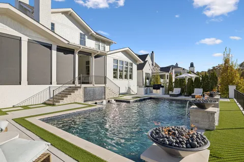 a view of a house with swimming pool and sitting area