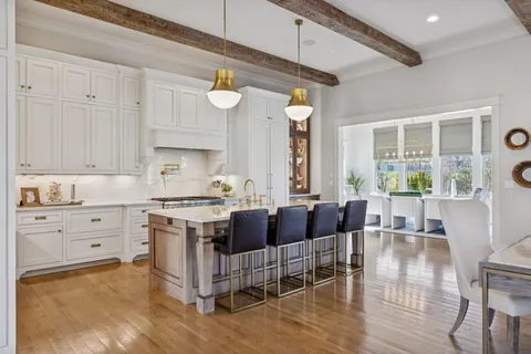 a living room with kitchen island furniture and a large window