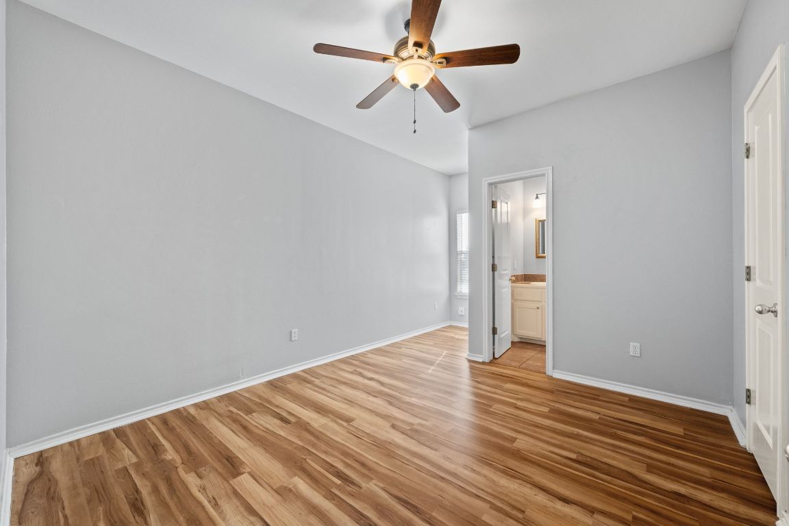 2906 Pearl Street, Unit B Austin, TX 78705 - Photo 20 of 30 Unfurnished bedroom featuring light wood finished floors, a ceiling fan, and ensuite bath