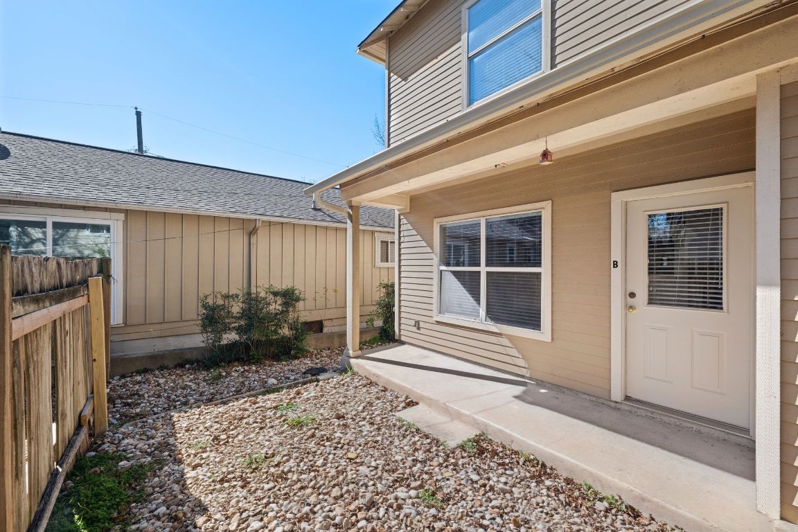 2906 Pearl Street, Unit B Austin, TX 78705 - Photo 2 of 30 Doorway to property featuring board and batten siding and a shingled roof